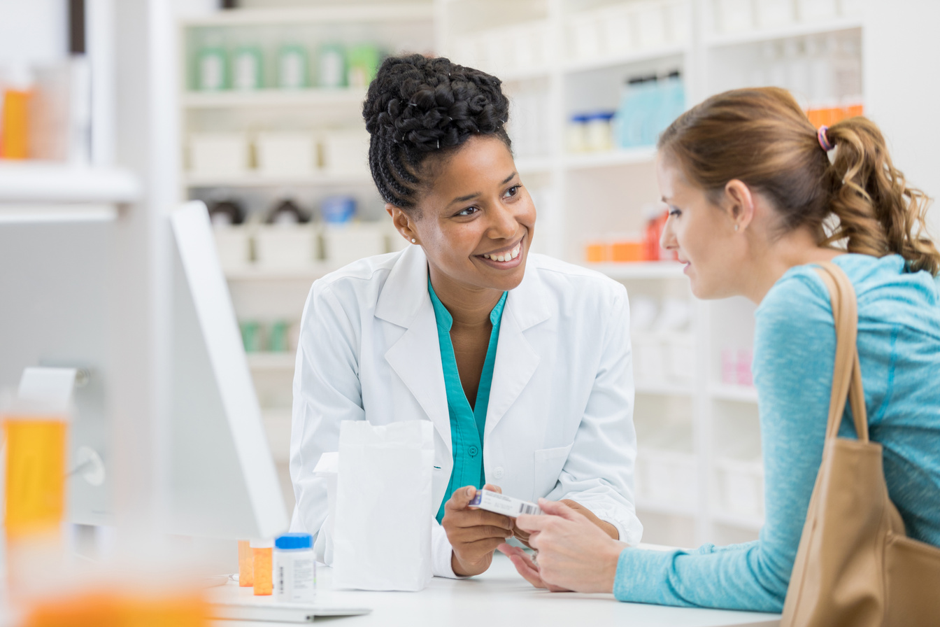 Pharmacist consults with female patient